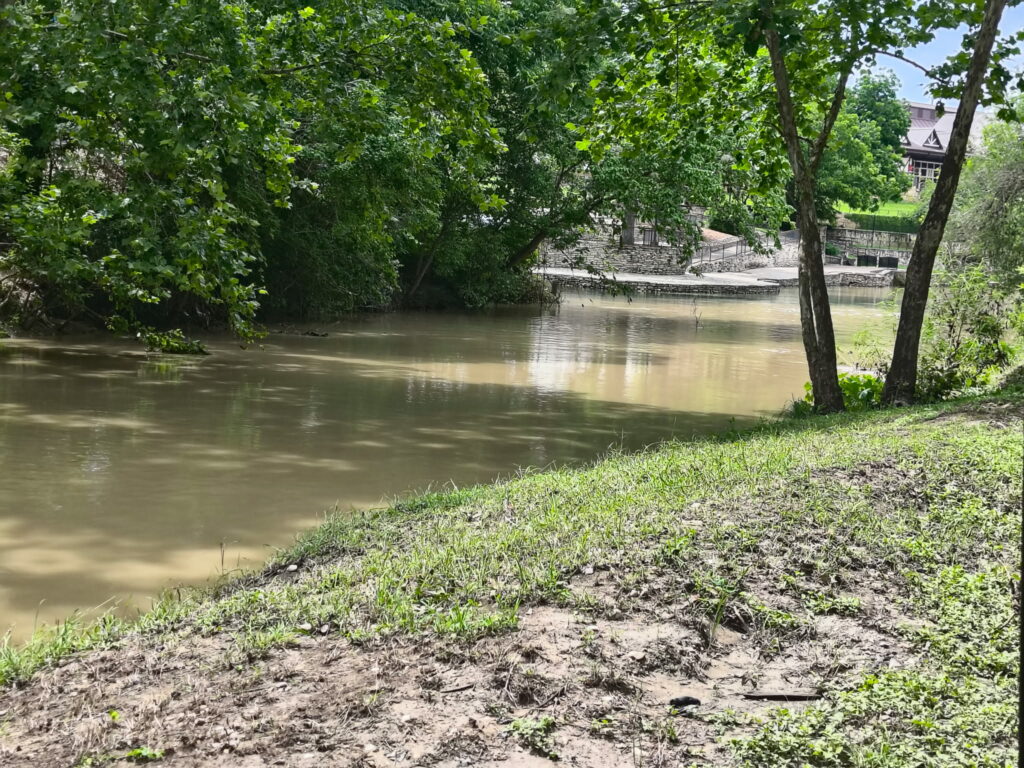 Dry Comal Creek meeting the Comal River in New Braunfels Texas bringing storm water runoff and debris