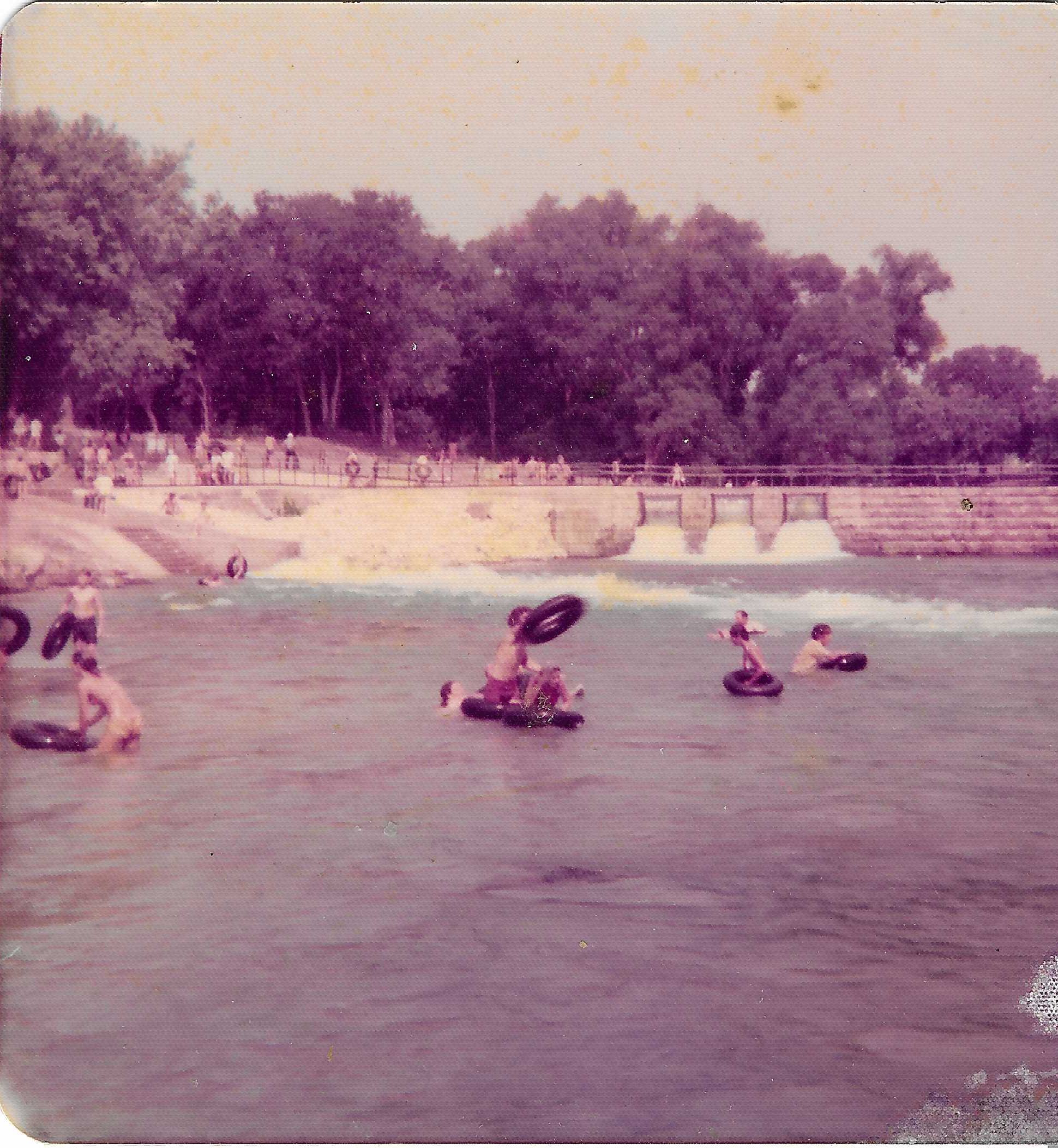 Historical 1977 photograph of the Comal River Tube Chute and Clemens Dam looking upstream from below in New Braunfels Texas