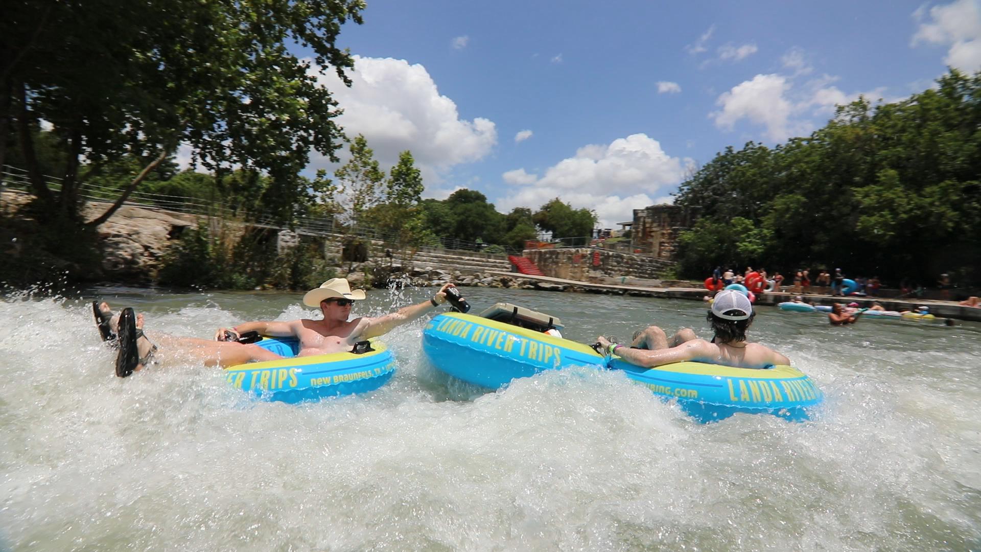 Landa River Trips guests riding through the Comal River Tube Chute in New Braunfels Texas