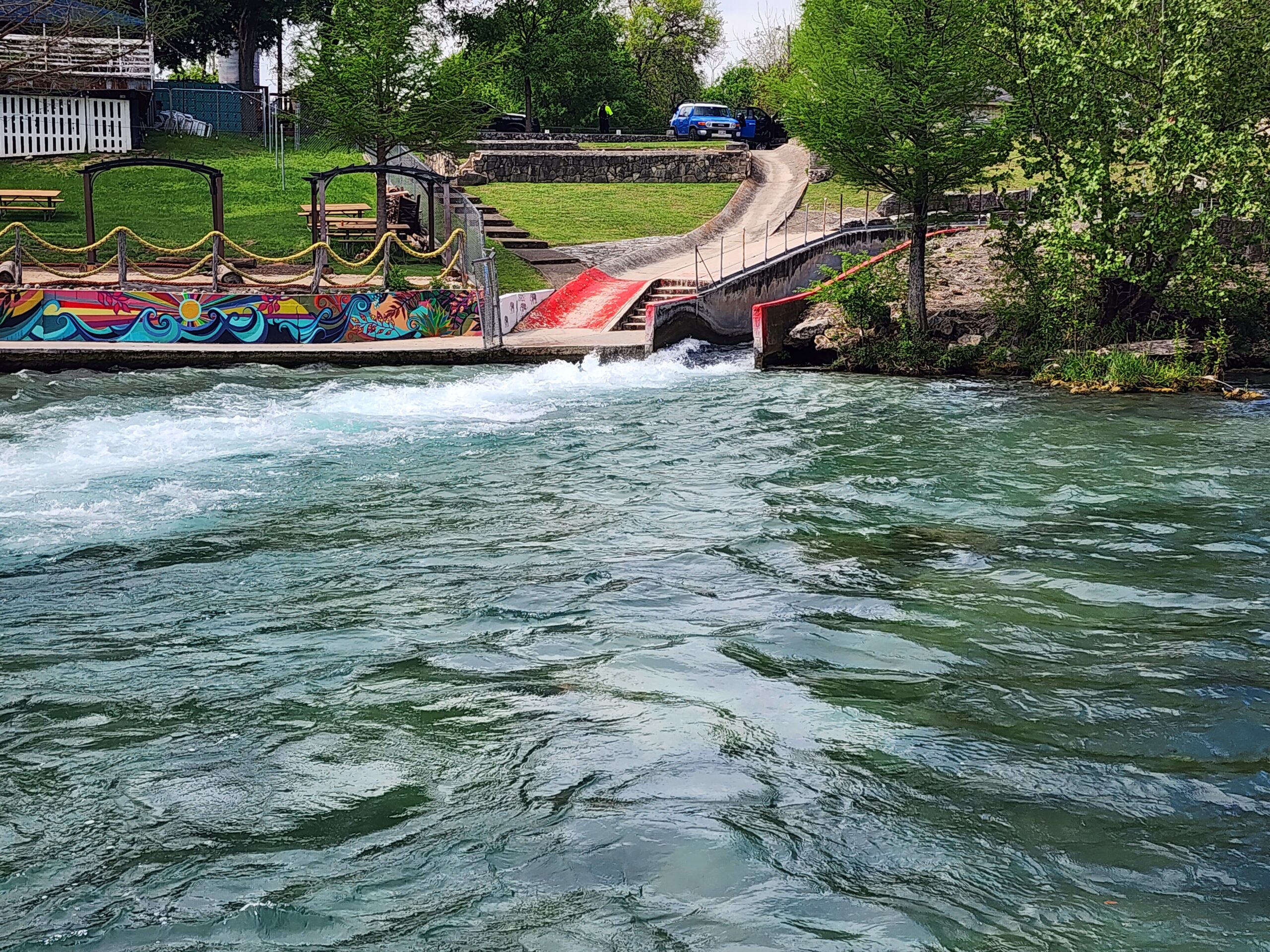 Comal River Tube Chute in New Braunfels Texas with colorful mural at Landa River Trips