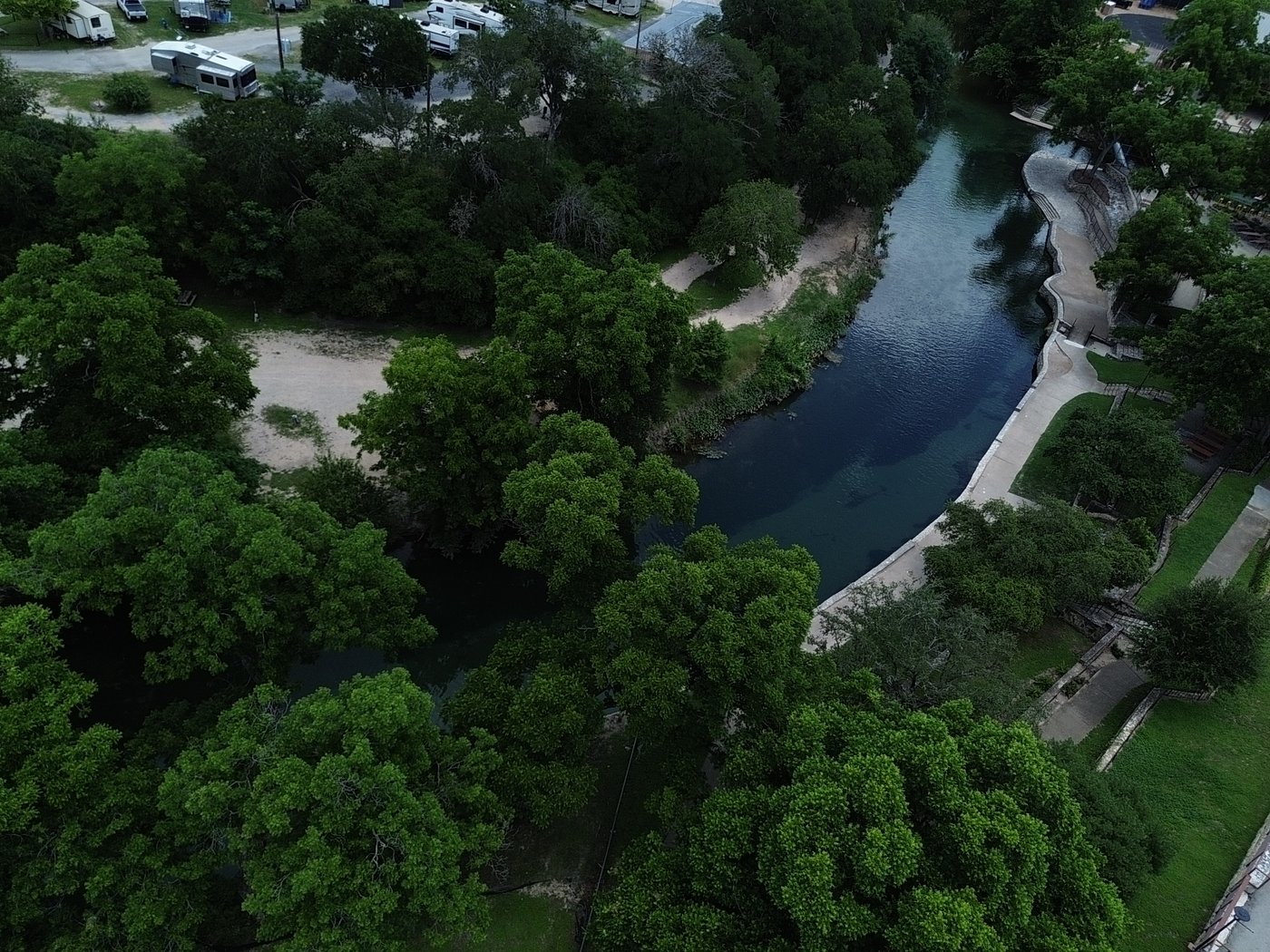 Aerial drone view of the Comal River and historic railroad bridge in New Braunfels Texas near Landa River Trips
