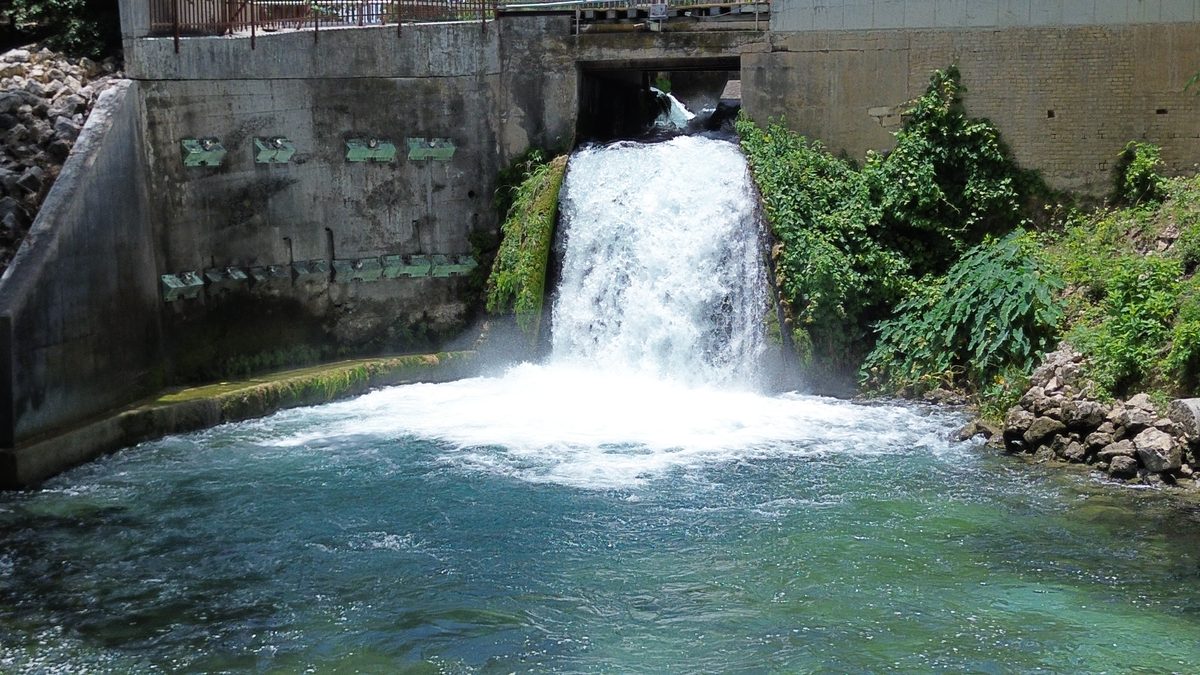 Historic mill waterfall on the Comal River in New Braunfels Texas viewed from Landa River Trips property