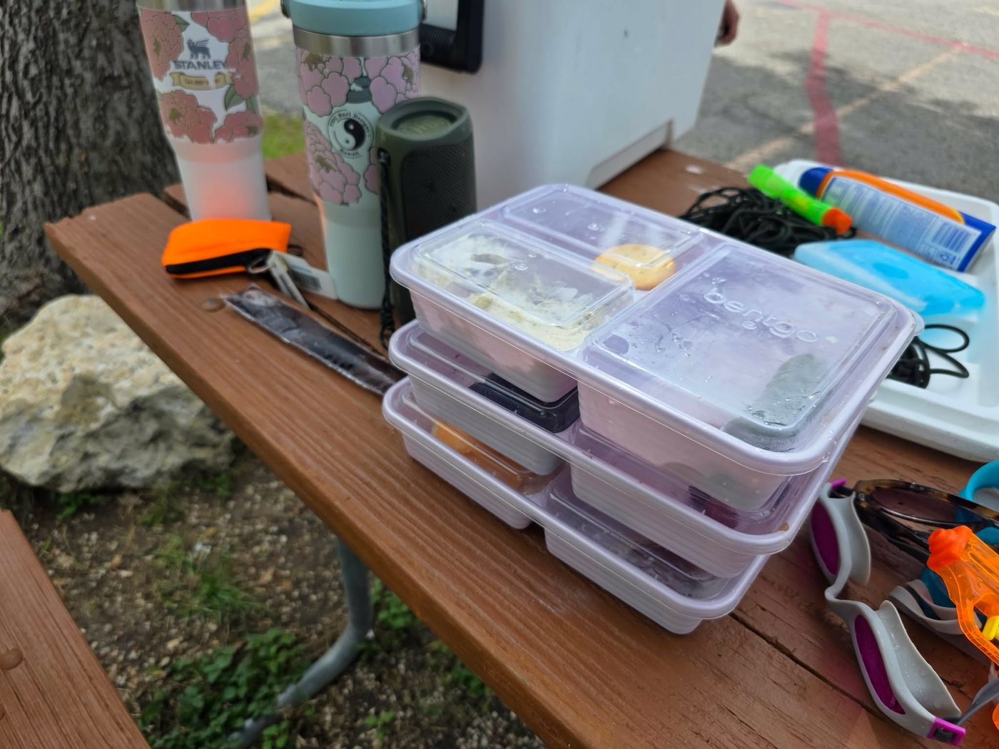 Snap-top reusable containers packed with food for a day tubing on the Comal River